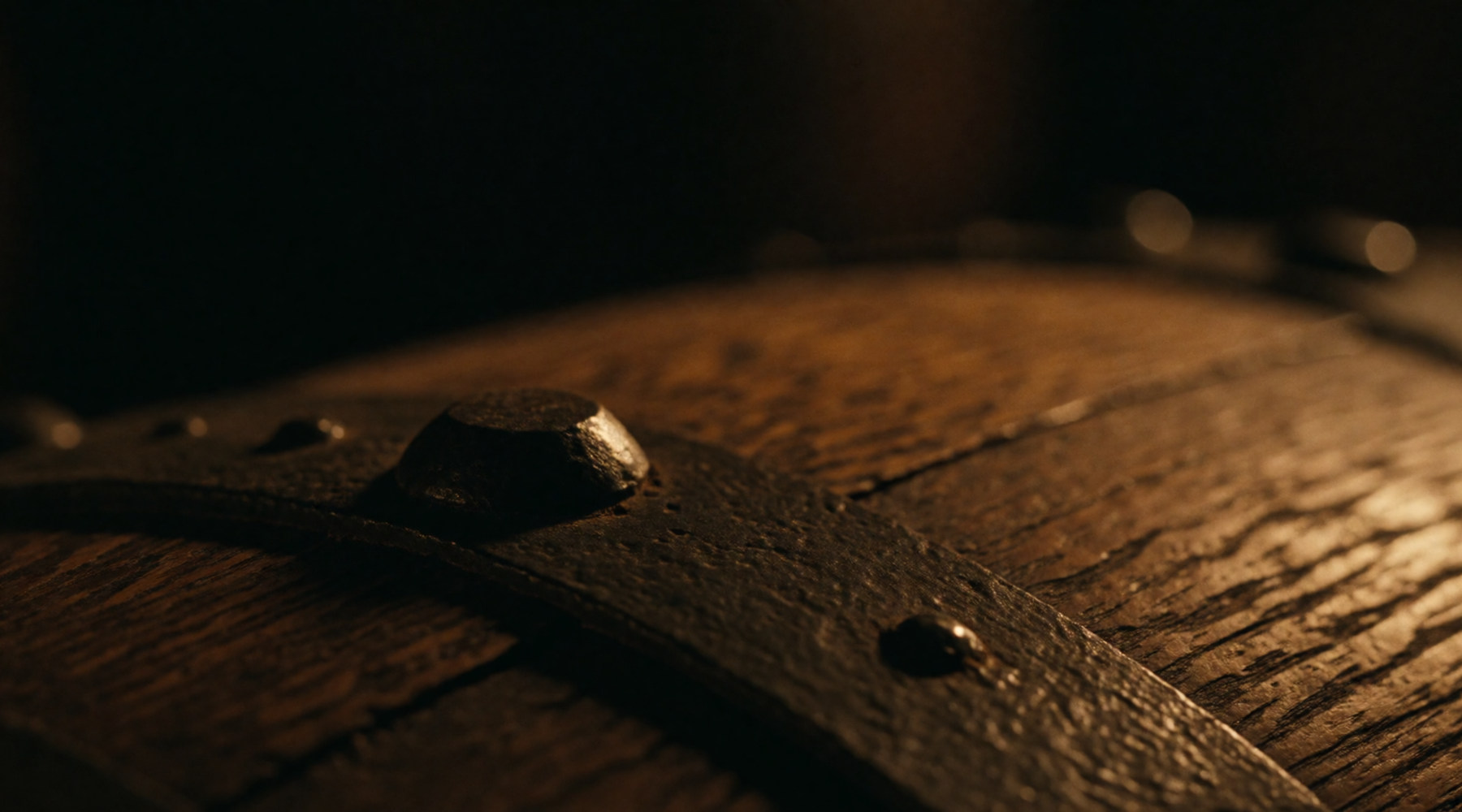 A black iron hoop banding an oak cask.